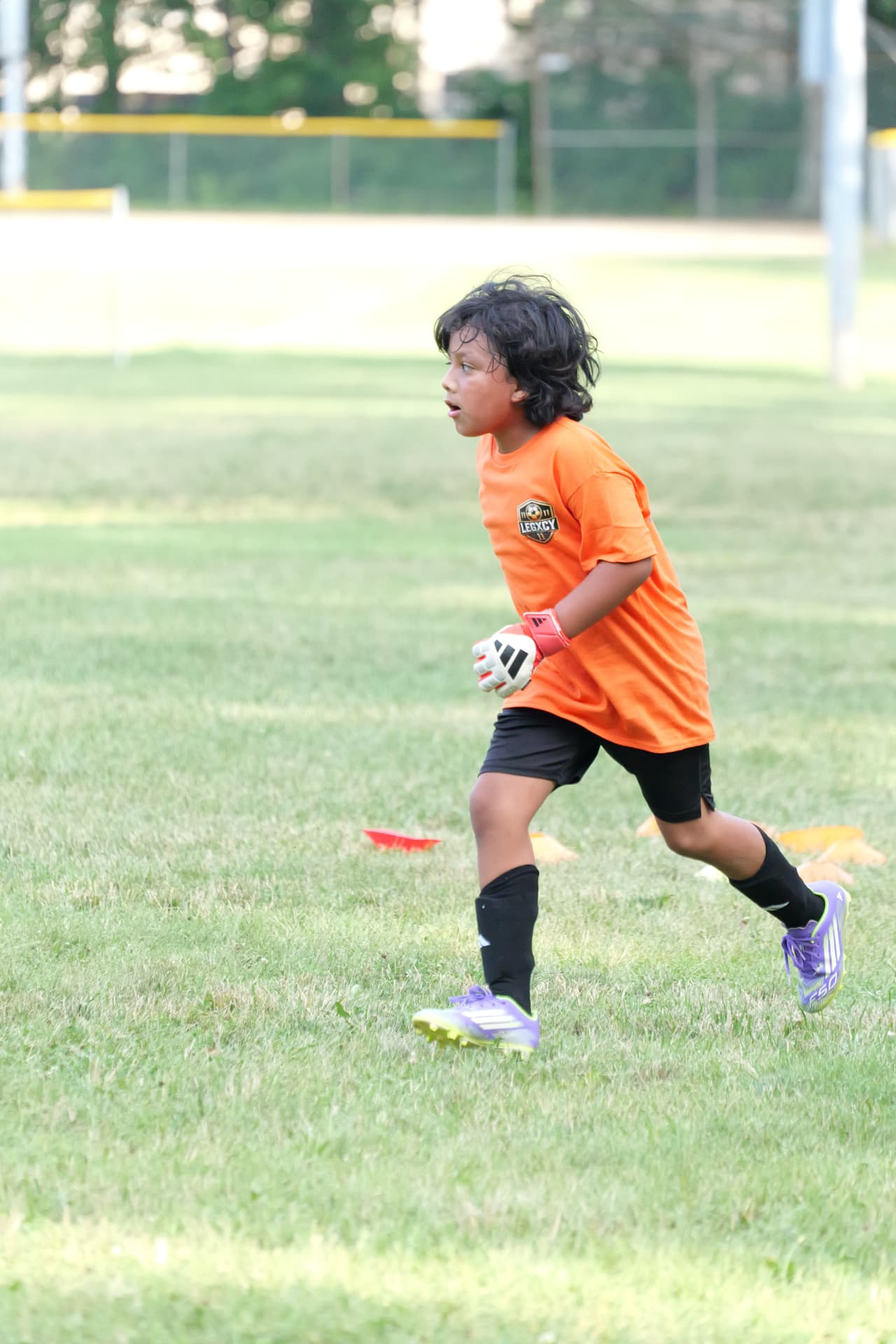 A young Legacy goalkeeper moving off the line during a session